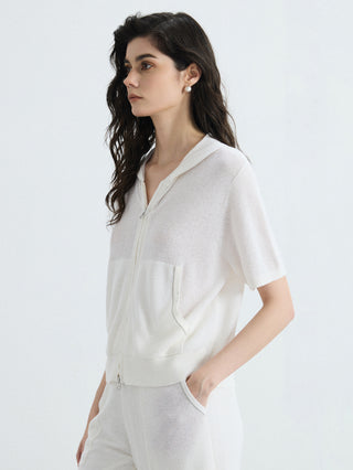 Ivory ribbed hooded zip-up top with front zip, patch pocket, and short sleeves.
