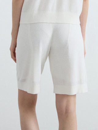 White relaxed ribbed knit shorts with draped front and side pockets