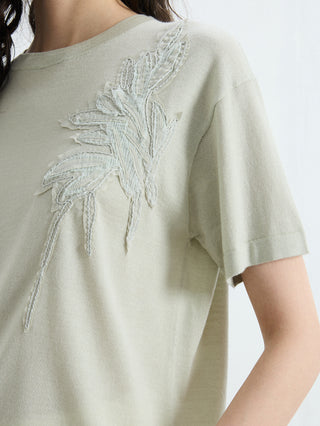 Matcha green knit tee close-up of tonal leaf embroidery on left chest