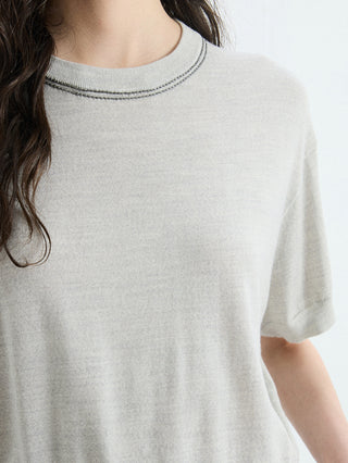 Close-up of gray cropped knit T-shirt with ribbed crew neckline and contrast trim