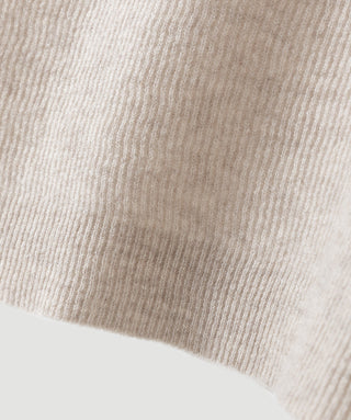 Cashmere knit fabric close-up, ribbed texture in light beige