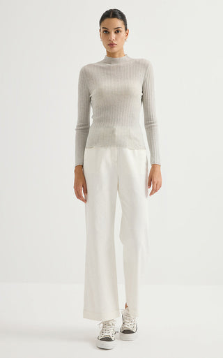 Light gray ribbed knit turtleneck sweater with long sleeves and light scalloped hem