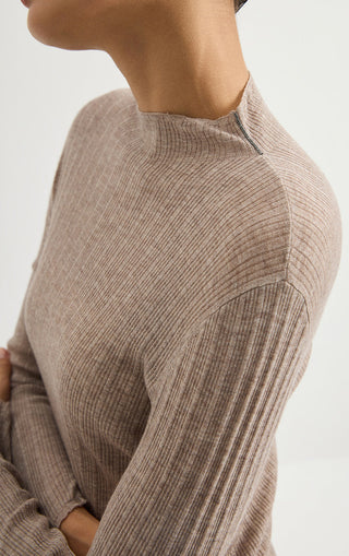 Light gray ribbed knit turtleneck sweater sleeve and shoulder close-up