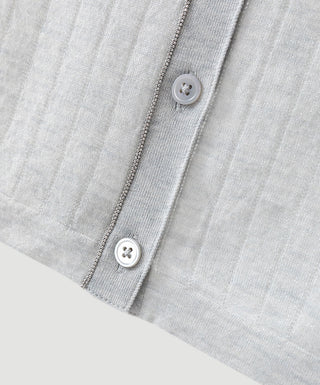 Wool-blend cardigan closeup: ribbed knit with metal-fleck trim and button placket