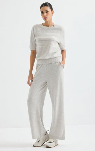 Light grey cashmere striped short-sleeve sweater on model, pants visible