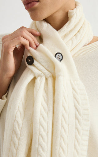 Ivory white cashmere button scarf close-up with round buttons and cable knit texture