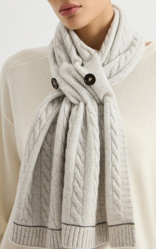 Light gray cashmere cable-knit button scarf close-up with buttons and ribbed cuff