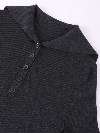Black wool polo knit close-up of ribbed collar and four-button placket