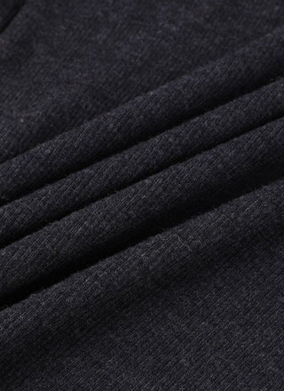 Black wool polo knit fabric close-up showing fine textured weave