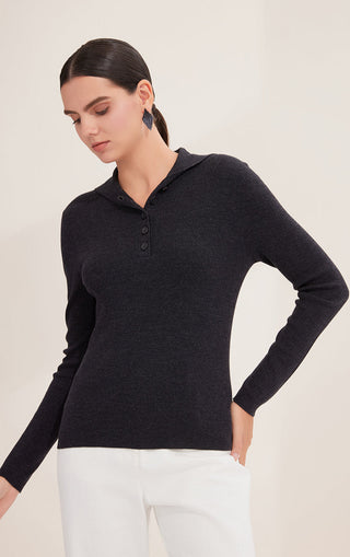 Black wool polo knit on model, long sleeves and buttoned neckline