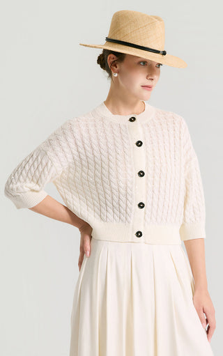 Ivory white textured cable-knit short cardigan, side view, black button placket