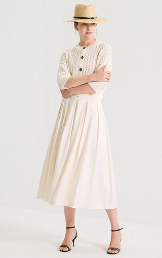 Ivory white short cardigan with cable knit texture and dark button front, three-quarter view