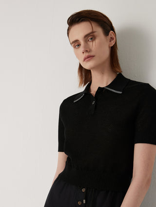 Black knit polo top with short sleeves, button placket, and beaded-trim collar edge.