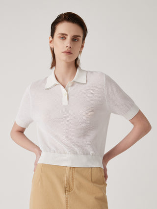 White knit polo-neck top with button placket and ribbed waistband hem detail.