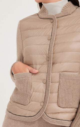Close-up of camel down knit jacket front with snap buttons and ribbed knit trim