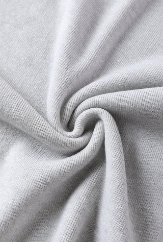 Light gray wool-blend knit fabric close-up with soft twist texture