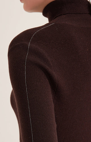 Dark brown knit turtleneck close-up with thin metallic side line