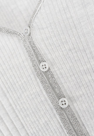 Beaded trim and round buttons on the white knit v-neck placket