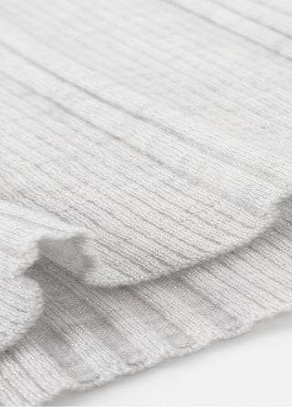 White ribbed knit fabric close-up with subtle sparkle texture near the cuff hem