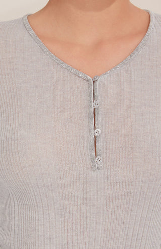 Close-up gray V-neck knit top with beaded button placket and trim detail