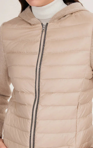 Close-up of camel hooded puffer jacket: quilted panels and zip front with pull tab