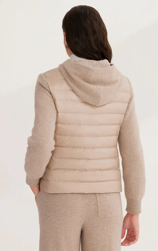 Back view of camel hooded knit puffer jacket with quilted back panel and ribbed hem