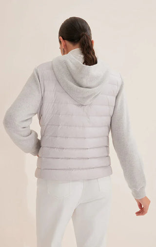 Back view of light gray hooded knit puffer jacket with quilted yoke and knit hem