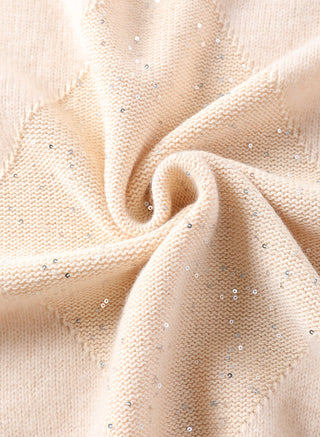 Camel cashmere knit fabric close-up with scattered sequin sparkle and texture