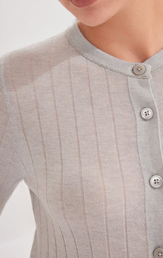 Close-up: gray-blue cardigan with round buttons and fine vertical ribbed knit pattern