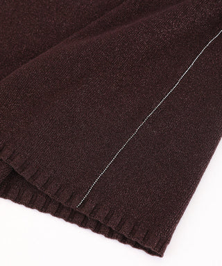 Close-up of brown side seam detail on half-sleeve knit top
