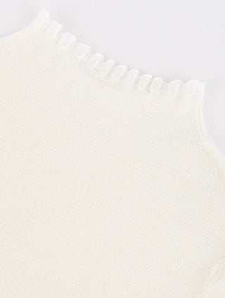 White knit top shoulder and ribbed crew neckline detail on textured fabric
