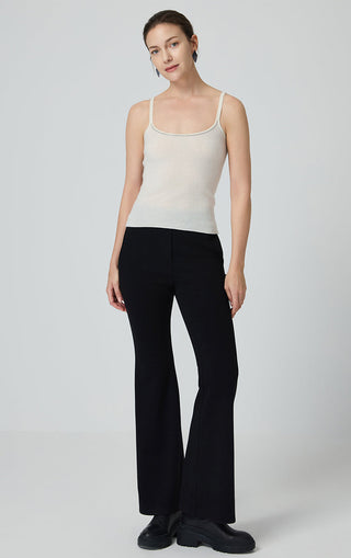 Beige cashmere knit camisole paired with black trousers, thin straps and scoop neck