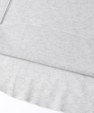 Gray-blue knit fabric close-up with fine texture and seam stitching