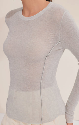 Close-up of gray-blue knit top with vertical ribbed seam stitching detail