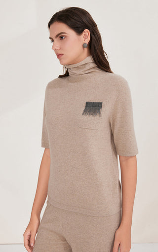 Camel short-sleeve turtleneck sweater with dark pocket appliqué and silver bead fringe
