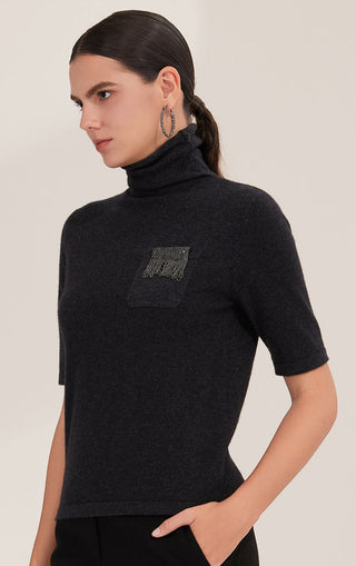 Black short-sleeve turtleneck knit sweater with embroidered bead fringe on pocket