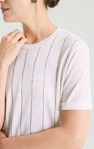 Close-up of white lurex stripe knit top with crew neck and short sleeves