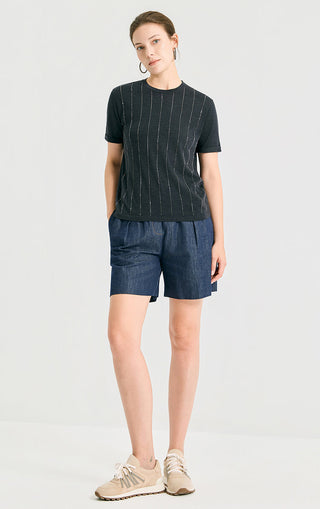 Dark vertical lurex knit top with crew neck, short sleeves, paired with denim shorts