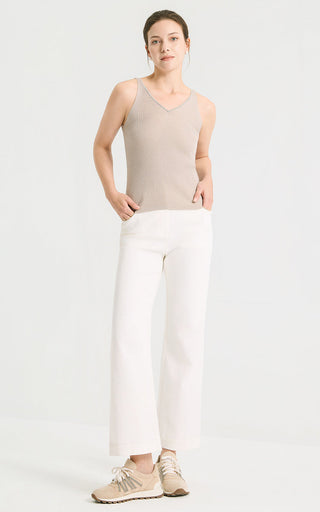 Camel wool-silk blend v-neck knit tank worn with white pants, full-length view.