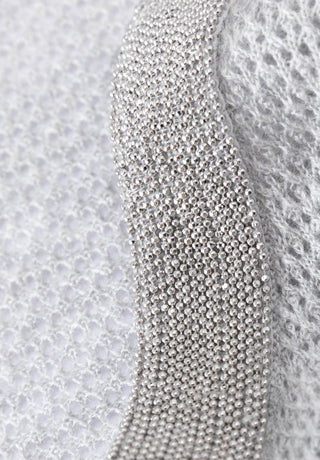 Silver beaded trim detail on a light gray knit tank shoulder panel