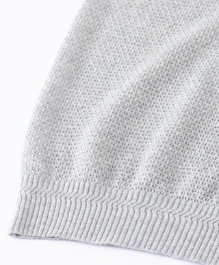 Light gray knit tank bottom hem with ribbed cuff and open-weave texture