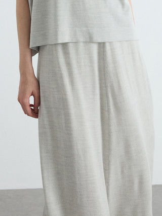 Oatmeal knit midi skirt close-up showing tiered/pleated drape from waist to hem