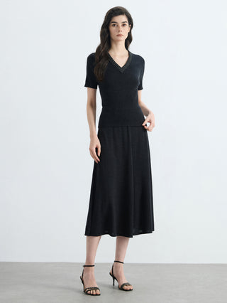 Black high-waisted A-line knit midi skirt with smooth knit texture and flared skirt