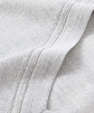 Light gray knit T-shirt with beaded trim along V-neck border