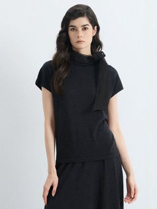 Black wool-silk knit blouse with ribbed mock neck and organza bow accent