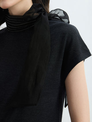Black knit blouse detail: organza bow at high neck with draped collar