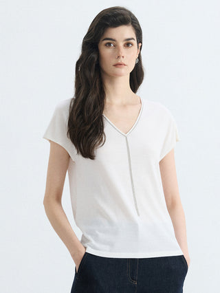 White wool-silk knit V-neck top with silver bead tassel at center seam