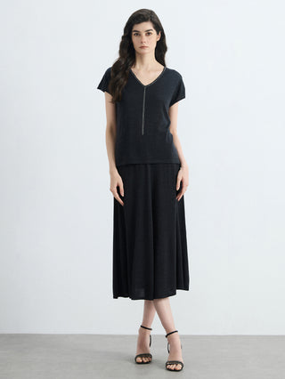 Black V-neck knit top with silver bead trim; short sleeves and straight fit