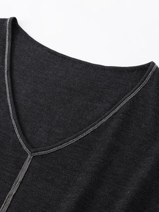 Black V-neck top neckline detail with silver bead trim along curved edge