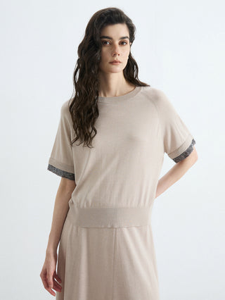 Beige wool-silk knit top with silver bead cuffs on short sleeves, draped silhouette